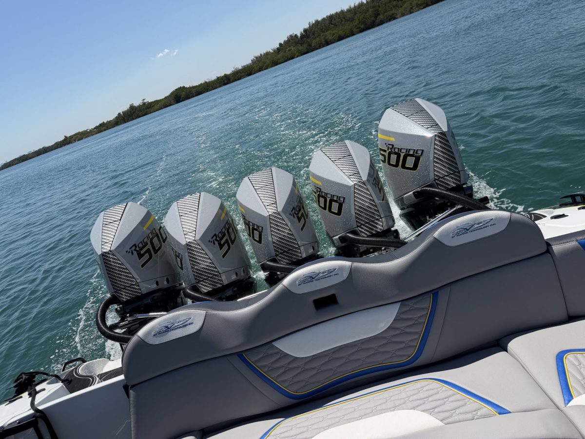 Quad outboard engines on the transom of a boat underway