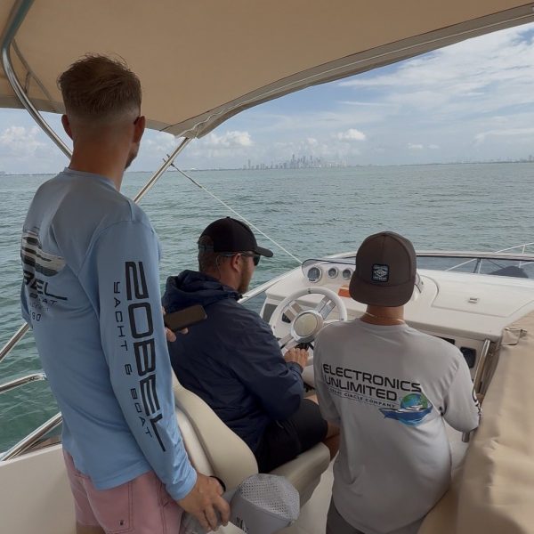 Crew aboard a vessel underway with an Electronics Unlimited technician
