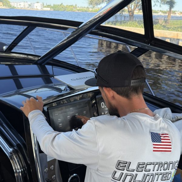 Technician configuring software on a vessel multifunction display