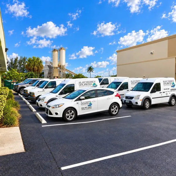 Electronics Unlimited service van fleet parked outside the Fort Lauderdale facility